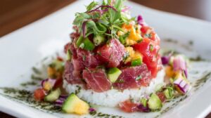 Ahi poke bowl with diced tuna, cucumber, avocado, herbs, and rice